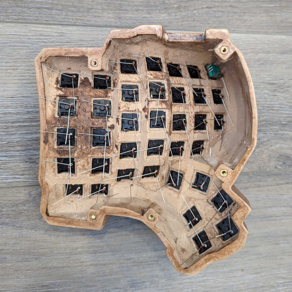 A keyboard half with diodes bent around one pin of the switch