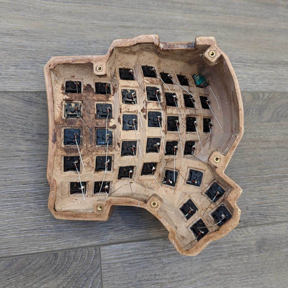 A keyboard half with diodes soldered to one pin of the switch