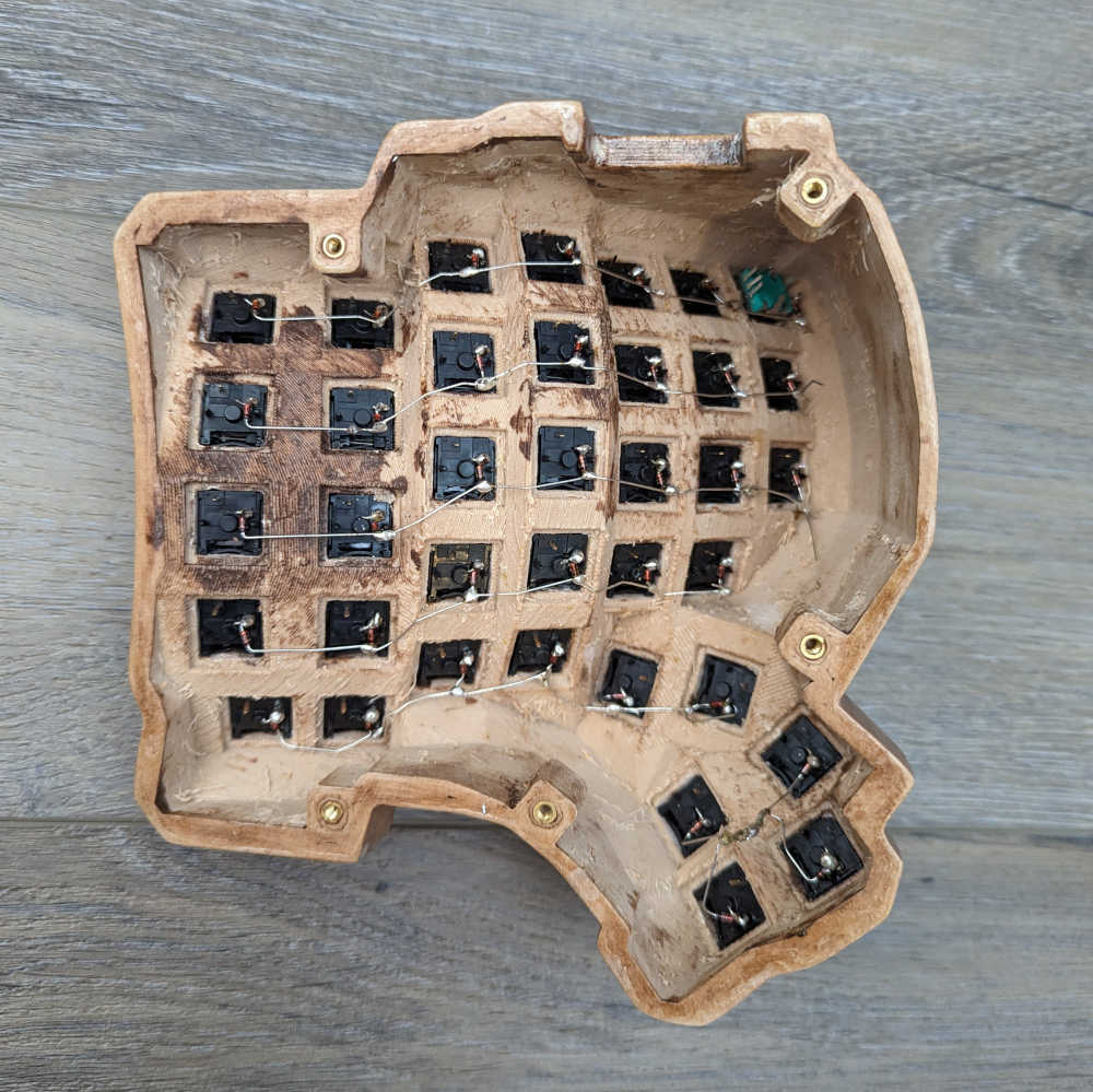 A keyboard half with diodes soldered together to form rows of the keyboard matrix